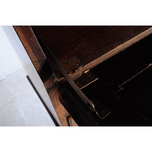 1003 - A 1920s George V oak bureau bookcase. The bureau being raised on shaped supports having a fall front... 