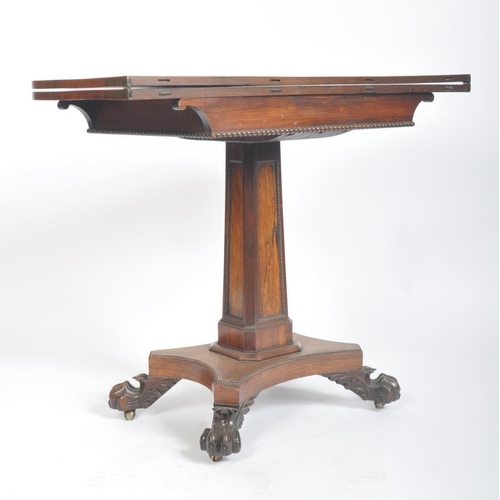 108 - A 19th century William IV rosewood games / card fold over table. The table having a rounded rectangu... 