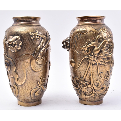 12 - A pair of 19th Century Chinese Qing Dynasty heavy cast bronze vases. Each vase having lipped rims wi... 