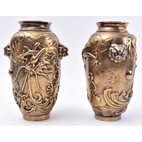 12 - A pair of 19th Century Chinese Qing Dynasty heavy cast bronze vases. Each vase having lipped rims wi... 