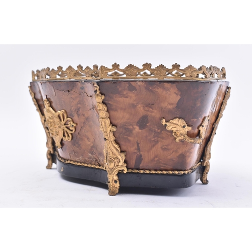 128 - A 19th century Victorian walnut and ormolu planter. The planter of serpentine form with ormolu worke... 