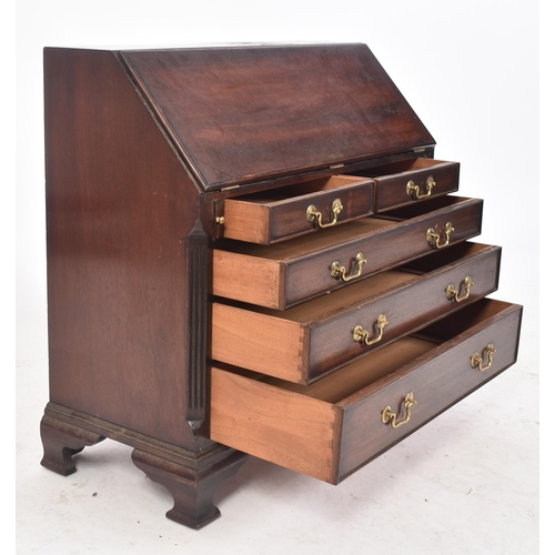 138 - A miniature George III style mahogany bureau. The Bureau desk having a fall front top section with f... 