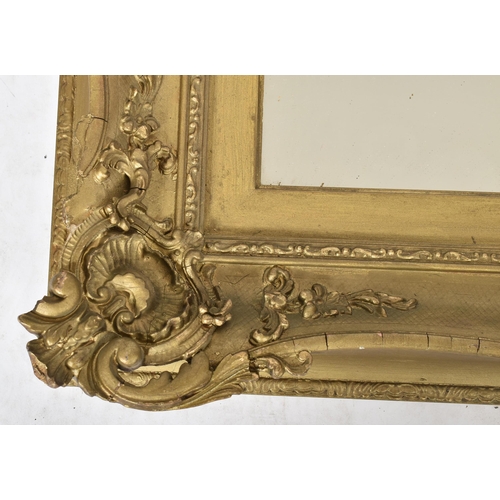 148 - A 19th century giltwood and gesso plaster framed hanging overmantel mirror. The plate mirror of rect... 