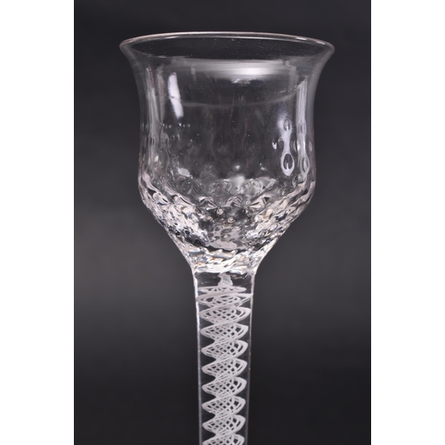 151 - A mid - late 18th century George III opaque air twist wine glass. The drinking glass with tapering r... 