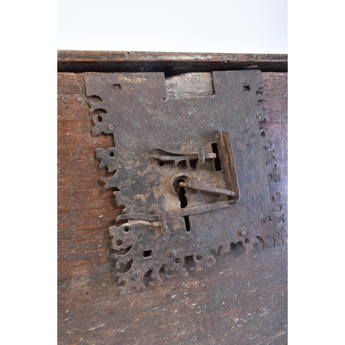 152 - A 17th century oak coffer chest of simple rectangular form. The coffer having a hinged top with cham... 