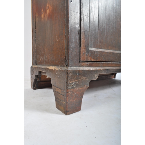 156 - An 18th century George III country oak housekeepers cupboard - press. Raised on bracket feet with fi... 