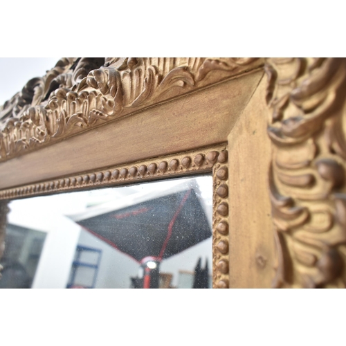 161 - A 19th century Rococo style gilt wood scroll leaf wall hanging mirror. The mirror having an intricat... 