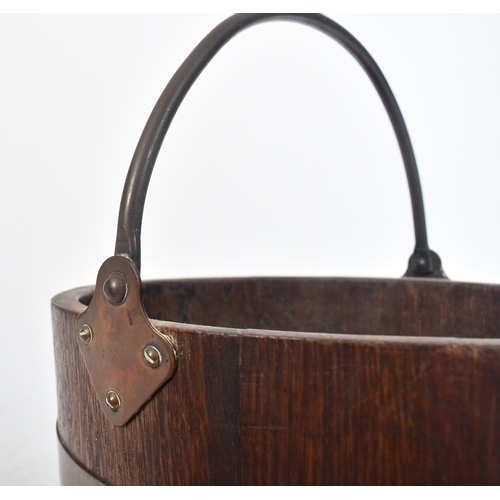 163 - A Victorian 19th century coopered oak brass bound bucket by R A Lister & Co. Ltd. of Dursley. The bu... 