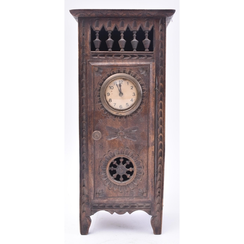 166 - A 19th century French Breton oak mantel clock. The provincial Breton oak case of upright form having... 