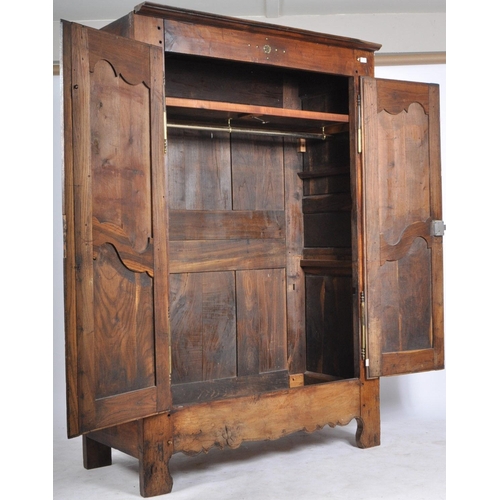 170 - An 18th century French oak / chestnut armoire - wardrobe. The armoire being highly carved  and set w... 