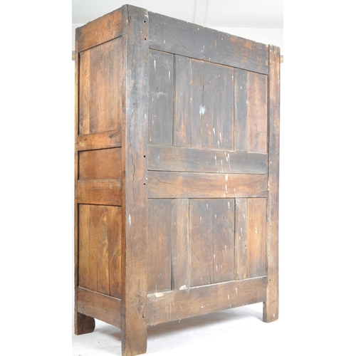 170 - An 18th century French oak / chestnut armoire - wardrobe. The armoire being highly carved  and set w... 