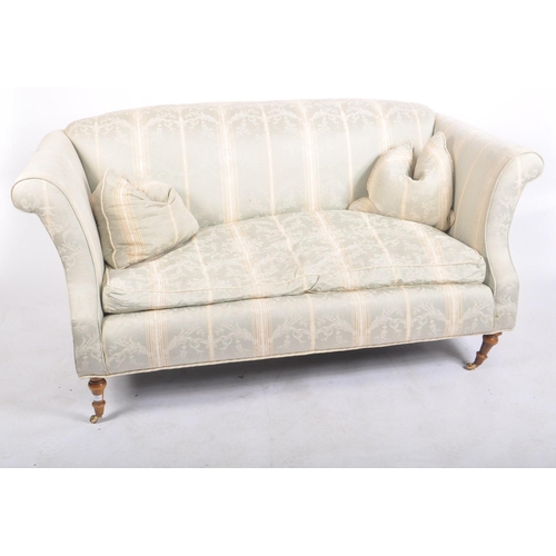 173 - A 20th century upholstered Chesterfield three seater sofa in the manner of Howard & Sons. The sofa h... 