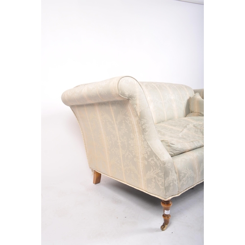 173 - A 20th century upholstered Chesterfield three seater sofa in the manner of Howard & Sons. The sofa h... 