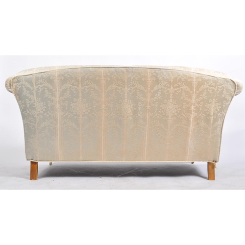 173 - A 20th century upholstered Chesterfield three seater sofa in the manner of Howard & Sons. The sofa h... 