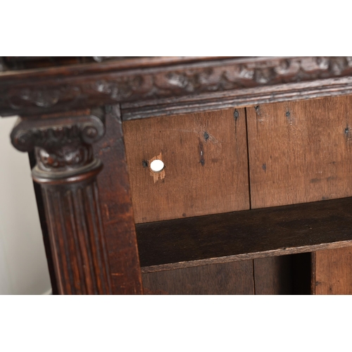 180 - A 17th century heavily carved oak Flemish cabinet on stand. The cabinet top having a flyaway cornice... 