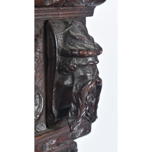 180 - A 17th century heavily carved oak Flemish cabinet on stand. The cabinet top having a flyaway cornice... 