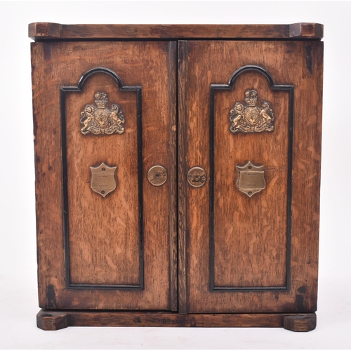 181 - A late Victorian 19th century oak humidor / table smoking cabinet. The humidor having twin panelled ... 