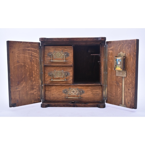 181 - A late Victorian 19th century oak humidor / table smoking cabinet. The humidor having twin panelled ... 