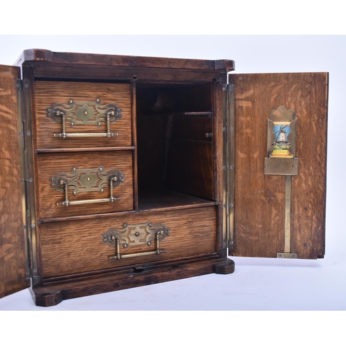 181 - A late Victorian 19th century oak humidor / table smoking cabinet. The humidor having twin panelled ... 