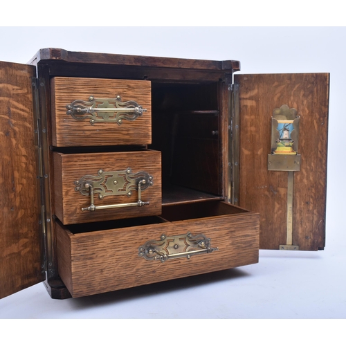 181 - A late Victorian 19th century oak humidor / table smoking cabinet. The humidor having twin panelled ... 