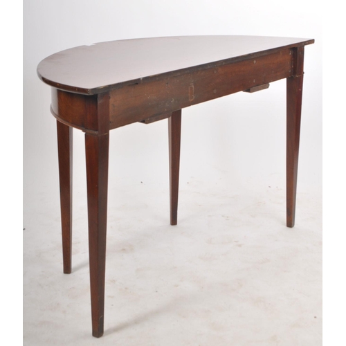 184 - A 19th century Victorian mahogany demi-lune hall table / side console table. The table having a deep... 