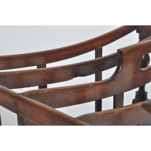 188 - A Victorian 19th century carved walnut Canterbury magazine rack. The rack having top central handle ... 