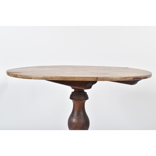 198 - An 18th century George III mahogany tilt top pedestal table. The table having a mahogany circular to... 