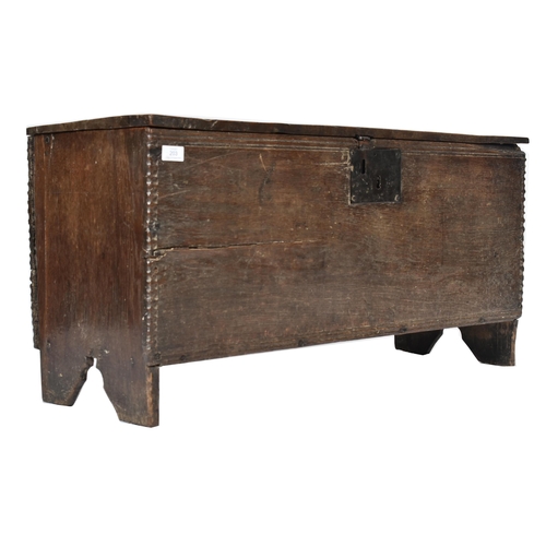 203 - A 17th century oak coffer chest of simple rectangular form. The coffer having a hinged top with cham... 