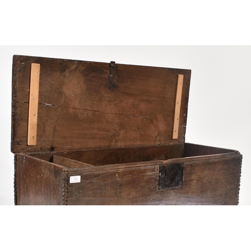 203 - A 17th century oak coffer chest of simple rectangular form. The coffer having a hinged top with cham... 