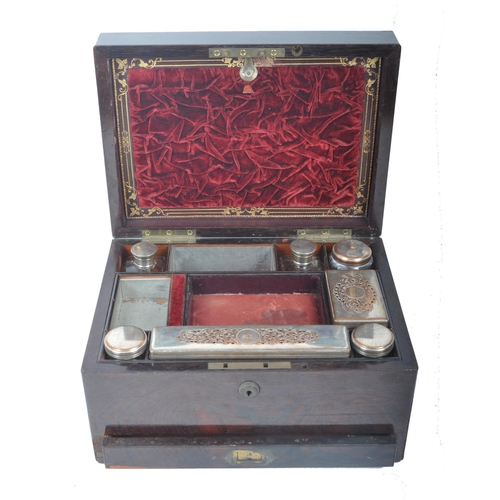 211 - A 19th century rosewood ladies travelling vanity case. The rosewood box with central oval brass mono... 