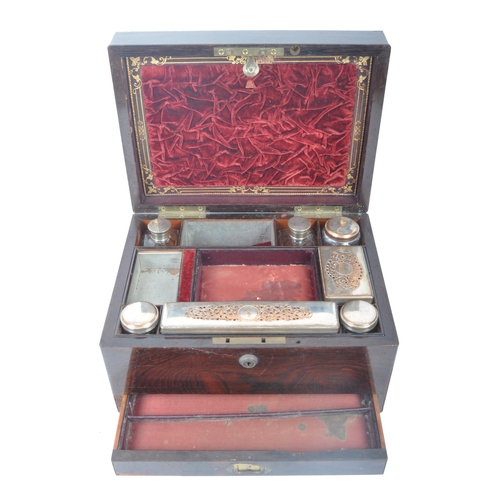 211 - A 19th century rosewood ladies travelling vanity case. The rosewood box with central oval brass mono... 