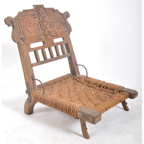 216 - A set of four early 20th century carved wood Indian Pida Rajasthani low chairs. Each having a carved... 