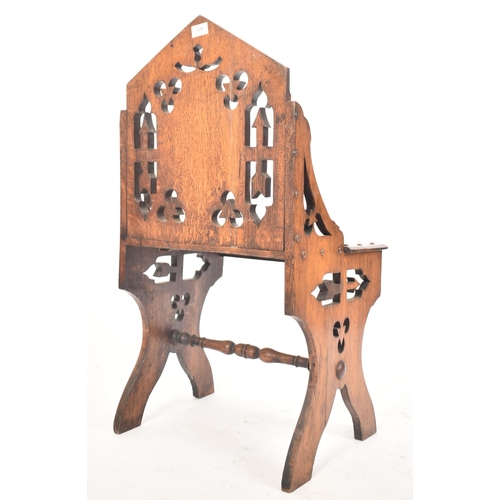 228 - A Victorian 19th century oak Gothic style ecclesiastical church low chair. The chair having a pierce... 