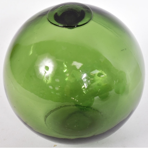 239 - Glass - a selection of four early 20th century hand-blown green glass fishing floats / witch balls. ... 