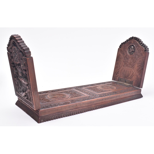 24 - A 19th century Chinese Cantonese carved wood book slide. The slide intricately carved throughout scr... 