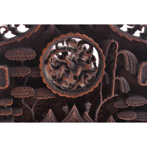 24 - A 19th century Chinese Cantonese carved wood book slide. The slide intricately carved throughout scr... 