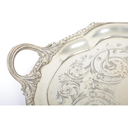 241 - An oversized 19th century large silver plated salver tray. The tray being raised on s-scroll termina... 