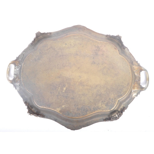 241 - An oversized 19th century large silver plated salver tray. The tray being raised on s-scroll termina... 