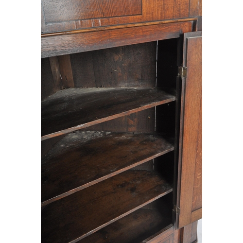 242 - A George III late 18th century oak & mahogany cross banded corner cupboard cabinet. The cabinet havi... 