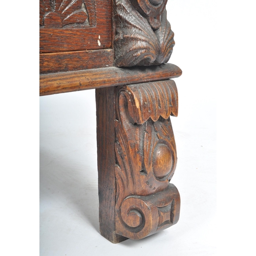 248 - A late 19th century Flemish Continental carved stained oak hall monk's settle bench. The bench decor... 