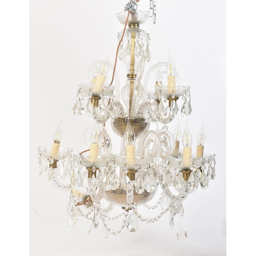 253 - A large 20th century two tier glass and brass chandelier. The chandelier having a central stem with ... 