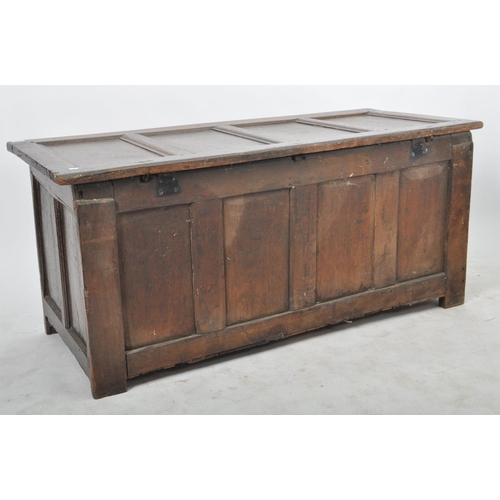 263 - A James I 17th century large country oak coffer chest. Raised on stile block legs with large, wide a... 