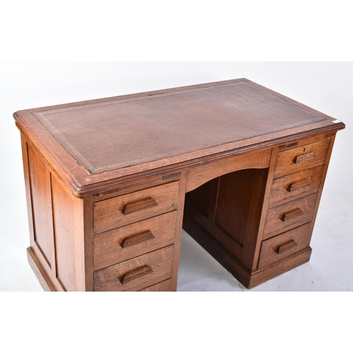 287 - A 20th century 1920s golden oak twin pedestal industrial office - factory desk. The desk having a ch... 