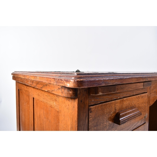 287 - A 20th century 1920s golden oak twin pedestal industrial office - factory desk. The desk having a ch... 