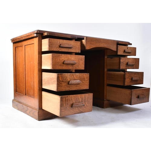 287 - A 20th century 1920s golden oak twin pedestal industrial office - factory desk. The desk having a ch... 