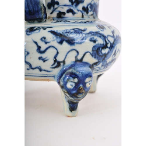 317 - A 19th century Chinese Qing Dynasty blue & white ceramic tripod censor. The censor having twin slip ... 