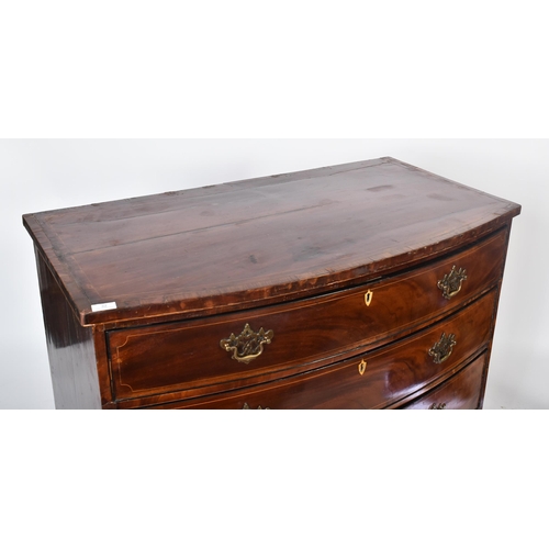 32 - A 19th century George III mahogany crossbanded bow front chest of drawers. The chest having a bank o... 