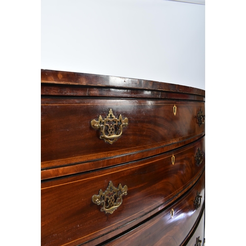 32 - A 19th century George III mahogany crossbanded bow front chest of drawers. The chest having a bank o... 