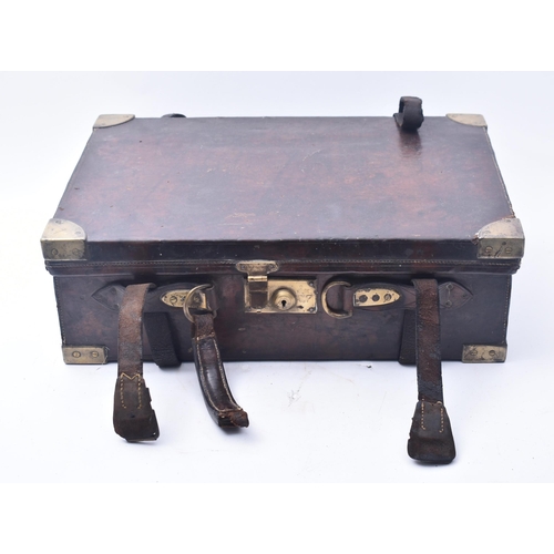 33 - James Woodward & Sons - An early 20th century leather and brass bound attaché case. The case once be... 