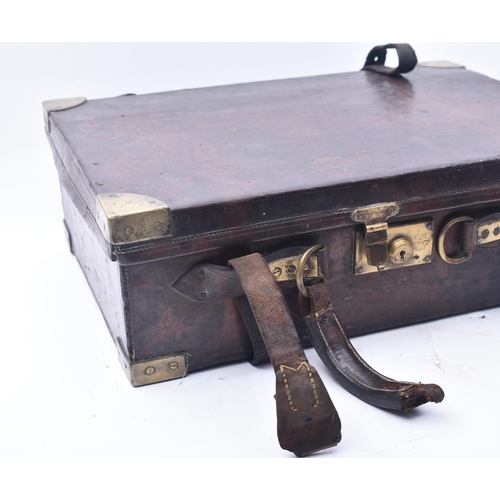 33 - James Woodward & Sons - An early 20th century leather and brass bound attaché case. The case once be... 